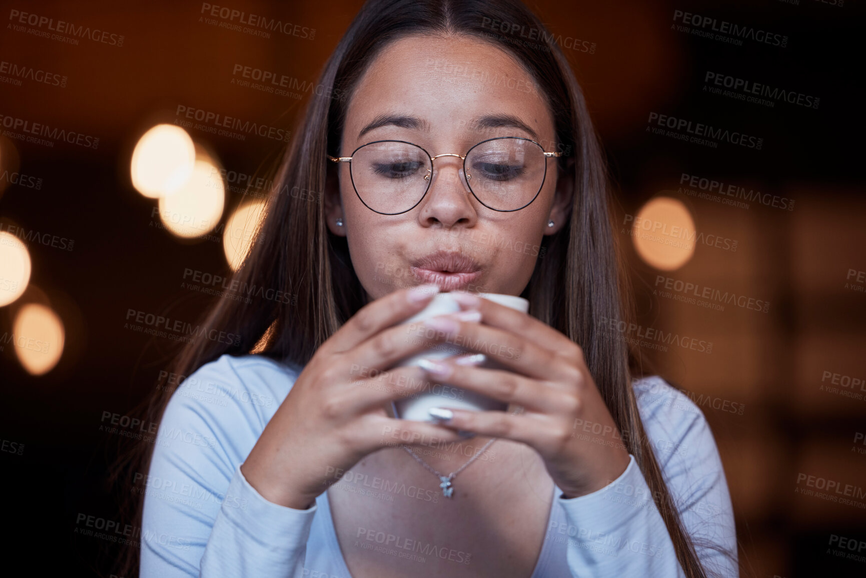 Buy stock photo Cafe, coffee and woman blow on warm tea cup, hot chocolate or espresso drink in retail shop, store or restaurant. Commerce service, relax and young thirsty person blowing cool air on latte beverage