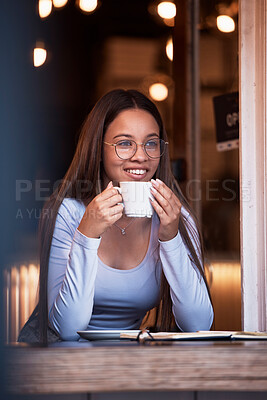 Buy stock photo Thinking, dark and happy with a woman in a coffee shop, sitting a table while feeling during the night. Idea, smile and time with an attractive young female drinking a fresh beverage in a cafe
