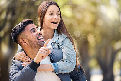 Buy stock photo Couple, outdoor and pointing at surprise for love, care and happiness together in summer. Young man and woman at nature park for piggyback, laughing or wow at space on happy date or vacation to relax