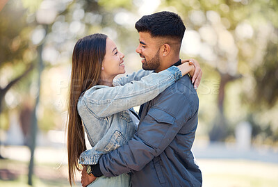 Buy stock photo Couple, hug and outdoor with a smile for love, care and happiness together in summer. Young man and woman at nature park for affection or trust on a happy and romantic date or vacation to relax