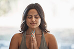 Yoga meditation, prayer hands and woman in home for health, wellness and exercise. Pilates, zen chakra and calm female yogi with namaste pose for holistic training, peace and mindfulness workout.