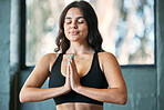 Yoga meditation, prayer hands and woman in home for health, wellness and exercise. Pilates, zen chakra and calm female yogi meditate with namaste for holistic training, peace and mindfulness workout.