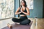 Yoga meditation, prayer hands and woman in gym for health, wellness and exercise. Pilates, zen chakra and calm female yogi meditate with namaste for holistic training, peace and mindfulness workout.
