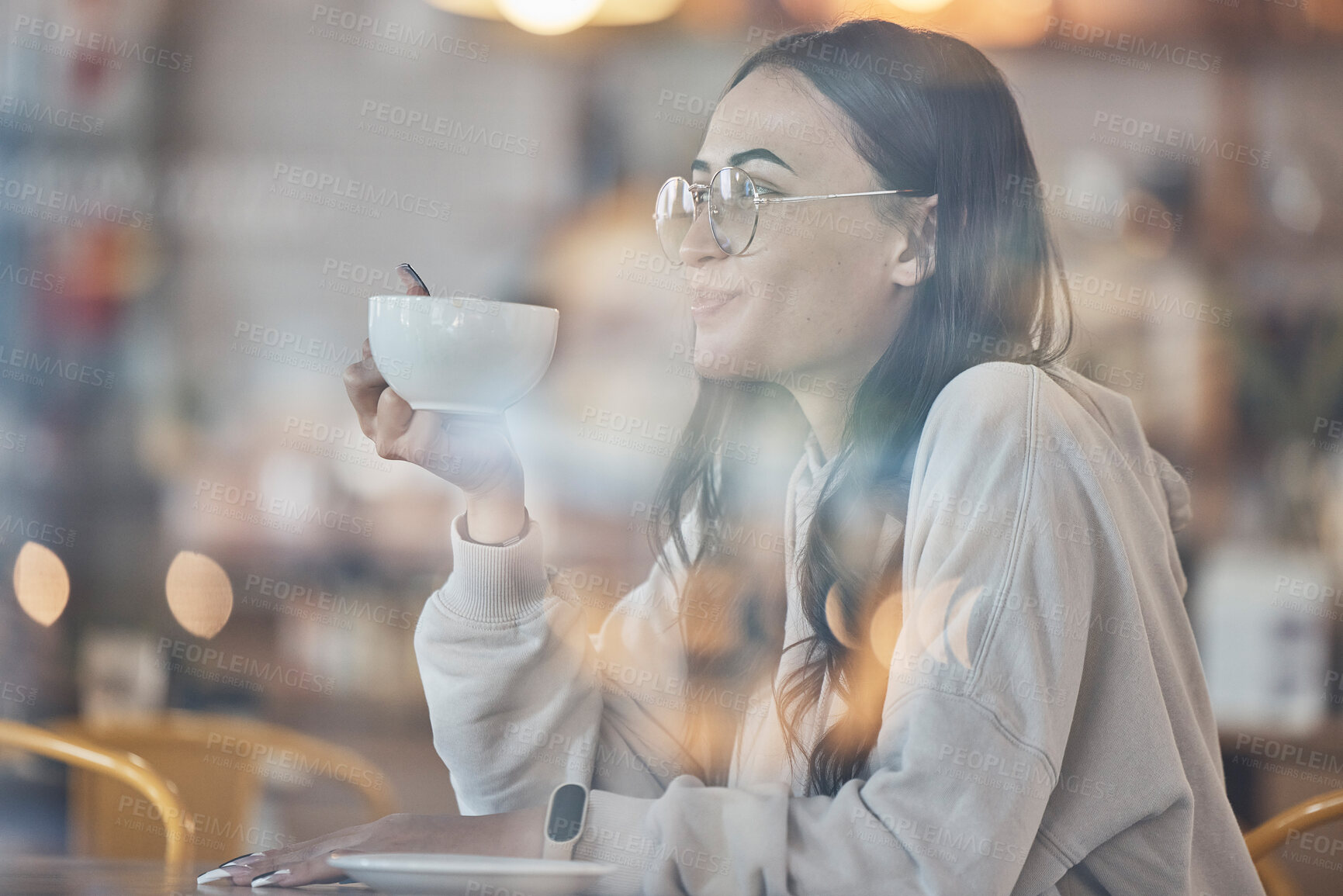 Buy stock photo Thinking, smile and a woman drinking coffee in a cafe to relax alone over the weekend behind glass. Idea, happy and caffeine with an attractive young female enjoying a beverage in a restaurant