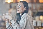 Thinking, happy and a woman drinking coffee in a cafe to relax alone over the weekend behind glass. Idea, smile and caffeine with an attractive young female enjoying a beverage in a restaurant