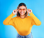 Fashion glasses, studio teen and happy woman with clothes, luxury designer brand or casual outfit style. Gen z summer aesthetic, teenager face portrait and young female model smile on blue background