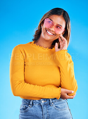 Buy stock photo Fashion, heart sunglasses and thinking happy woman with casual spring clothes, designer brand glasses or outfit style. Gen z aesthetic, trendy idea and young female model on blue background studio