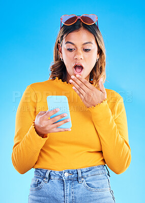 Buy stock photo Notification, shocked and woman surprised by phone due to trending social media news isolated in a studio blue background. Wow, omg and young female amazed by a cellphone using internet or online