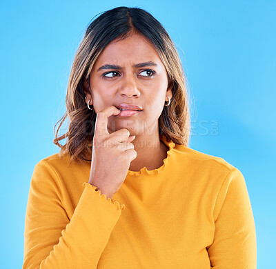 Buy stock photo Thinking, doubt and worry with a woman on a blue background in studio feeling unsure or uncertain. Idea, confused and problem solving with a young female looking for a solution or asking a question