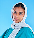 Muslim, woman and portrait with scarf on blue background, studio and color backdrop. Young female model, islamic culture and beauty of empowerment, proud religion and arabic fashion of elegant hijab