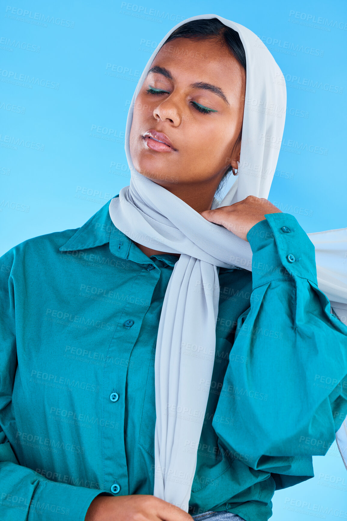 Buy stock photo Calm muslim, woman and beauty of hijab in studio, blue background or color backdrop. Young female model, islamic culture and scarf with eyes closed in empowerment, religion and elegant arabic fashion