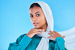 Woman, muslim and portrait of hijab in studio, blue background or color backdrop. Young female model, islamic culture or scarf for peace, religion and arabic fashion of eid mubarak, beauty or ramadan