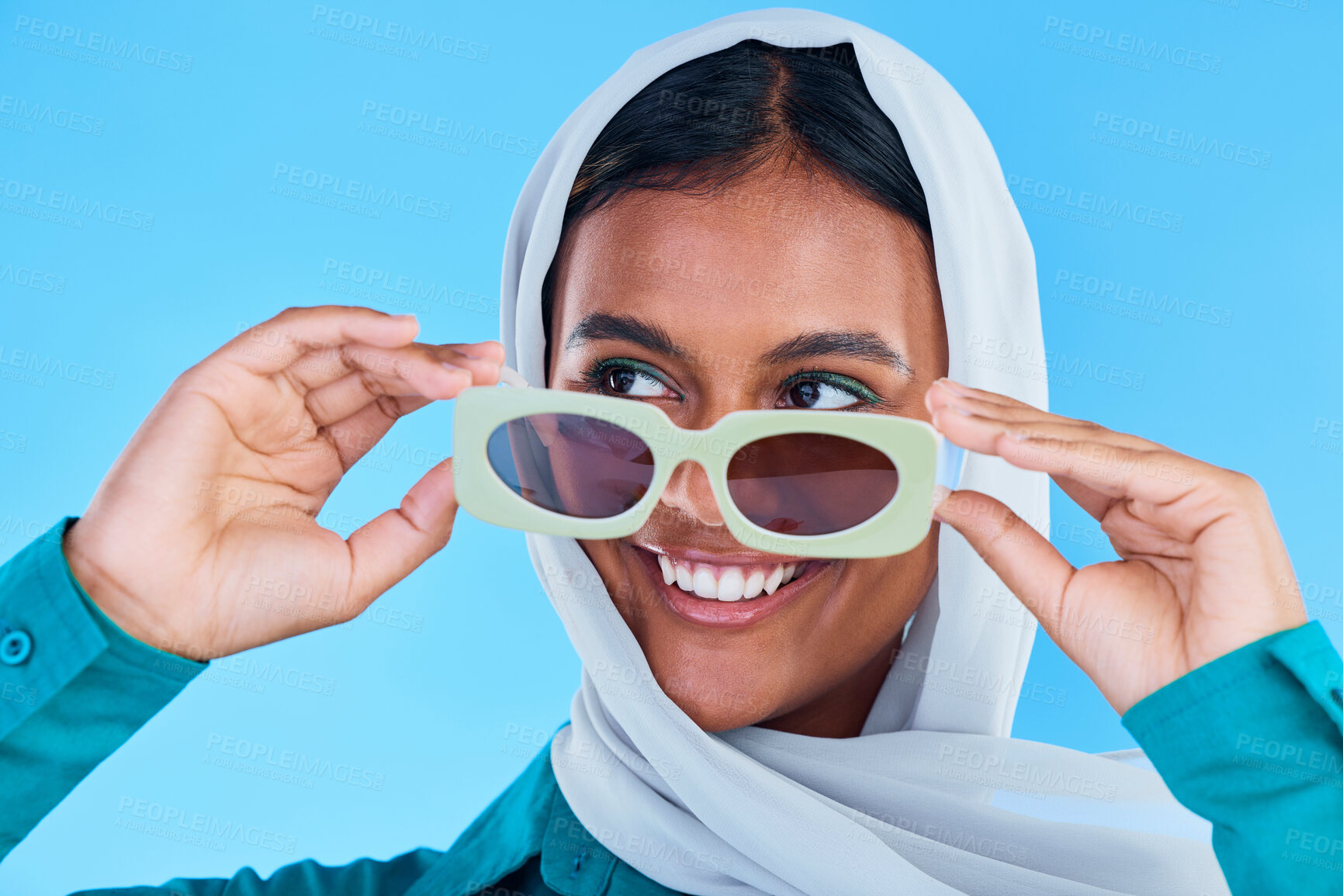 Buy stock photo Fashion sunglasses, face or happy Muslim woman with hijab, designer brand glasses or casual outfit style. Gen z summer aesthetic, Islamic model smile and Arabic Islam female on blue background studio
