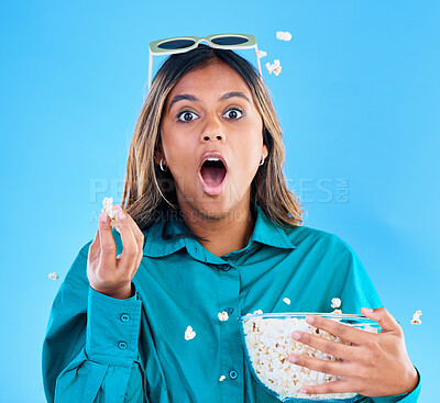 Buy stock photo 3D glasses, popcorn and wow with a woman in studio on a blue background looking shocked while eating a snack. Portrait, movie and video entertainment with an attractive young female feeling surprised