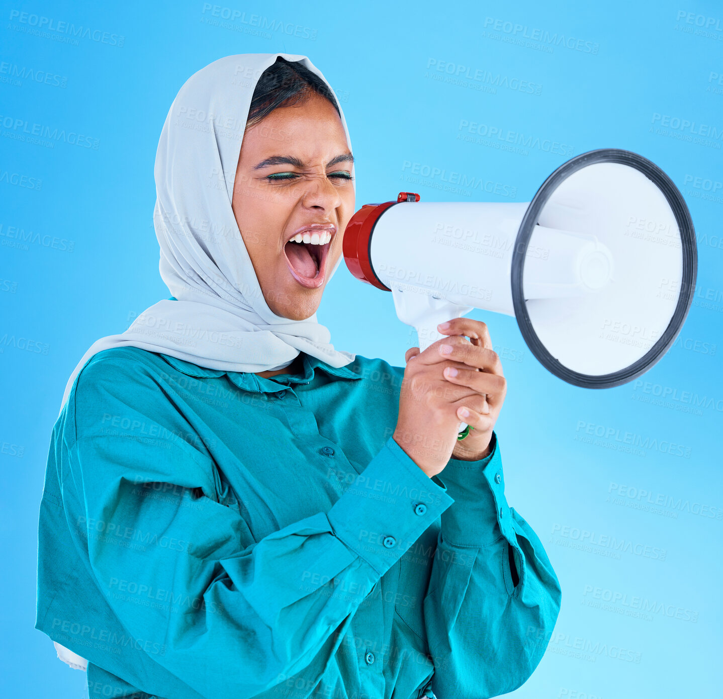 Buy stock photo Young woman, muslim and megaphone in studio for protest, human rights and scream by blue background. Girl, islam and loudspeaker for speech, justice and vote for freedom, mission and power politics
