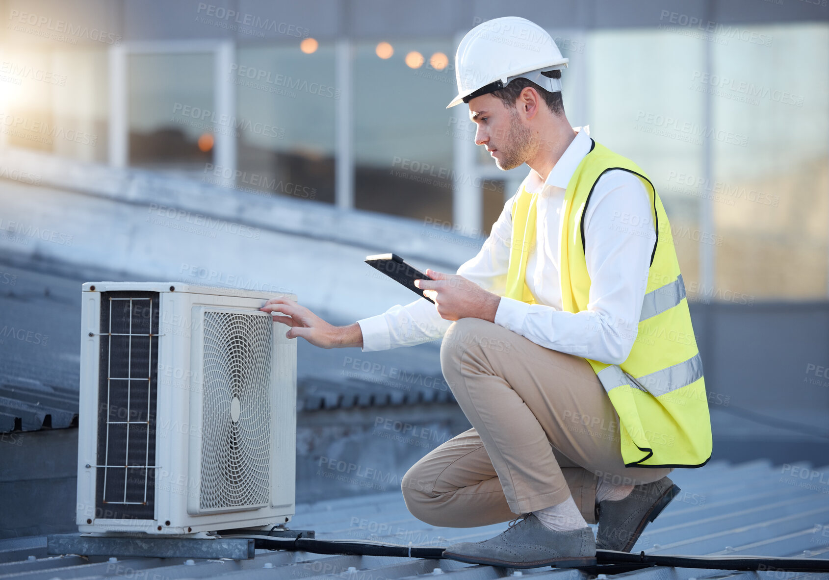 Buy stock photo Man, tablet and air conditioning maintenance on roof with tech, digital analysis and test. Technician, mobile touchscreen and urban rooftop for ac repair at building, industry or development in city