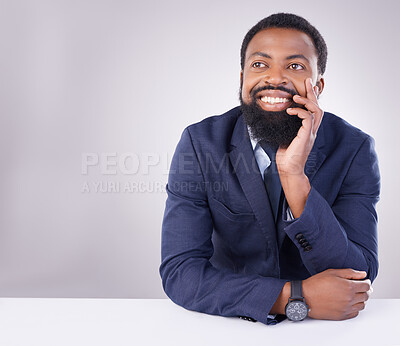 Buy stock photo Happy, thinking and a black man sitting by a table isolated on a white background in a studio. Smile, thoughtful and an African businessman with an idea, thought or contemplation on a backdrop