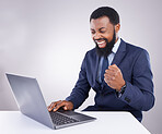 Winner black man on laptop isolated on a white background stock market, trading success or business bonus and fist pump. Yes, winning and person celebrate sales, profit or goals on computer in studio