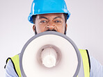 Engineering black man, megaphone and construction in studio portrait for angry shouting by white background. Engineer, architect or manager with loudspeaker in workplace with anger on frustrated face