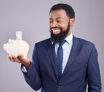 Black man, piggy bank and smile for financial investment or savings against a white studio background. Happy African American businessman smiling holding cash or money pot for investing in finance