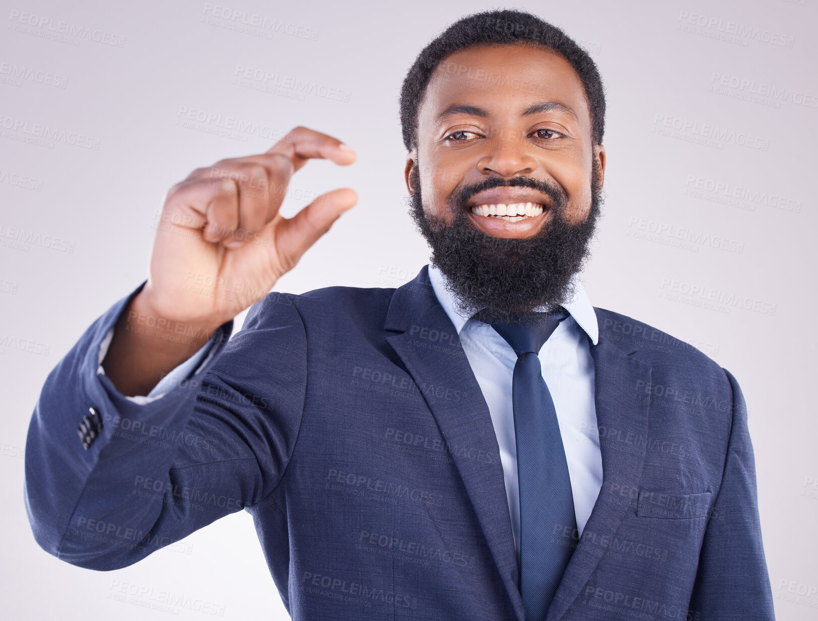 Buy stock photo Hand gesture, size and a business black man in studio on a gray background to measure company growth. Corporate, small or tiny with a happy african american male employee showing a measurement