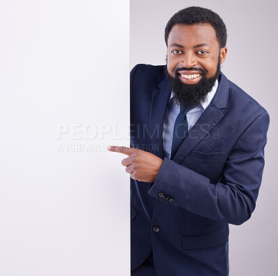 Buy stock photo Business portrait, black man and pointing to board in studio, white background and mockup space. Happy corporate worker, model and advertising poster, marketing news sign and brand on mock up banner