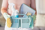 Woman, hands and cleaning equipment in housekeeping for disinfection or dirt removal at home. Hand of female cleaner holding basket of clean supplies or detergent for disinfect, hygiene or services