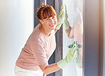 Woman, portrait smile and cleaning window for housekeeping, services or disinfection. Happy female cleaner smiling and wiping windows with cloth and rubber gloves for clean glass, hygiene or shine