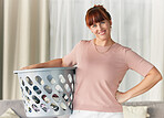 Laundry, basket and portrait of woman doing washing, housework or cleaning clothes in home or house. Service, happy and female in living room to spring clean fabric, clothing and holding a container