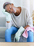 Housework, exhausted and woman cleaner on a sofa taking a break while spring cleaning a home. Tired, stress and African female maid or housewife sleeping in the living room after working at a home.