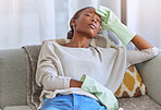 Spring cleaning, exhausted and female cleaner on a sofa taking a break while doing housework in a home. Tired, stress and African female maid or housewife sleeping in the living room after working.