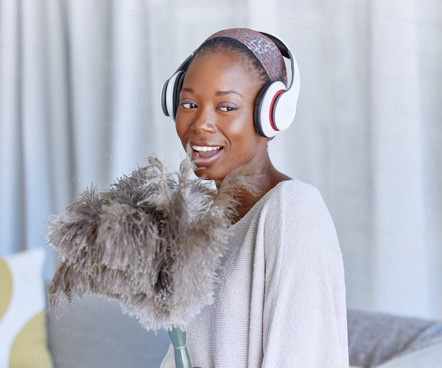 Buy stock photo Happy, black woman and cleaning with headphones music, singing and enjoying radio while housekeeping. Smile, duster and an African girl listening to a podcast or audio to clean the living room