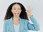 Business woman, okay sign and wink emoji in studio for agreement, support and success. Face portrait of female person with hand gesture for thank you, perfect or approval isolated on white background