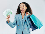 Business woman, money fan and studio with bag, shopping and excited face for discount by white background. Businesswoman, cash and smile for saving, retail sale and profit with happiness by backdrop