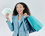 Business woman, portrait and shopping bags with money excited for sale or discount against a white studio background. Excited and happy female shopper smiling with cash or profit for retail happiness