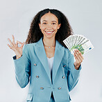 Portrait, happy and cash with a business woman in studio on a gray background making a perfect hand gesture. Face, finance and money with a female employee holding euro bills for investment