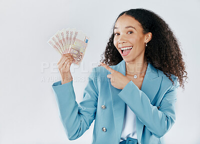 Buy stock photo Portrait, pointing and cash with a business woman in studio on a gray background for financial freedom. Smile, finance and money with a happy female employee holding euro bills for investment