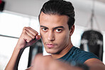 Portrait, boxer punch and man in gym ready to start workout, training or exercise. Boxing sports, wellness and face of serious male athlete throwing fist for fight, exercising or mma for strength.