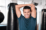 Portrait, stretching arm and man in gym ready to start workout, training or exercise. Sports smile, health fitness and happy male athlete warm up, stretch or prepare for exercising for flexibility.