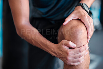 Buy stock photo Hands, knee and injury with a sports man holding his joint in pain while training in a gym for health. Fitness, accident and anatomy with a male athlete suffering from an injured body during exercise