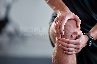 Buy stock photo Hands, knee and pain with a sports man holding a joint injury while training in a gym for health. Fitness, accident and anatomy with a male athlete suffering from an injured body during exercise