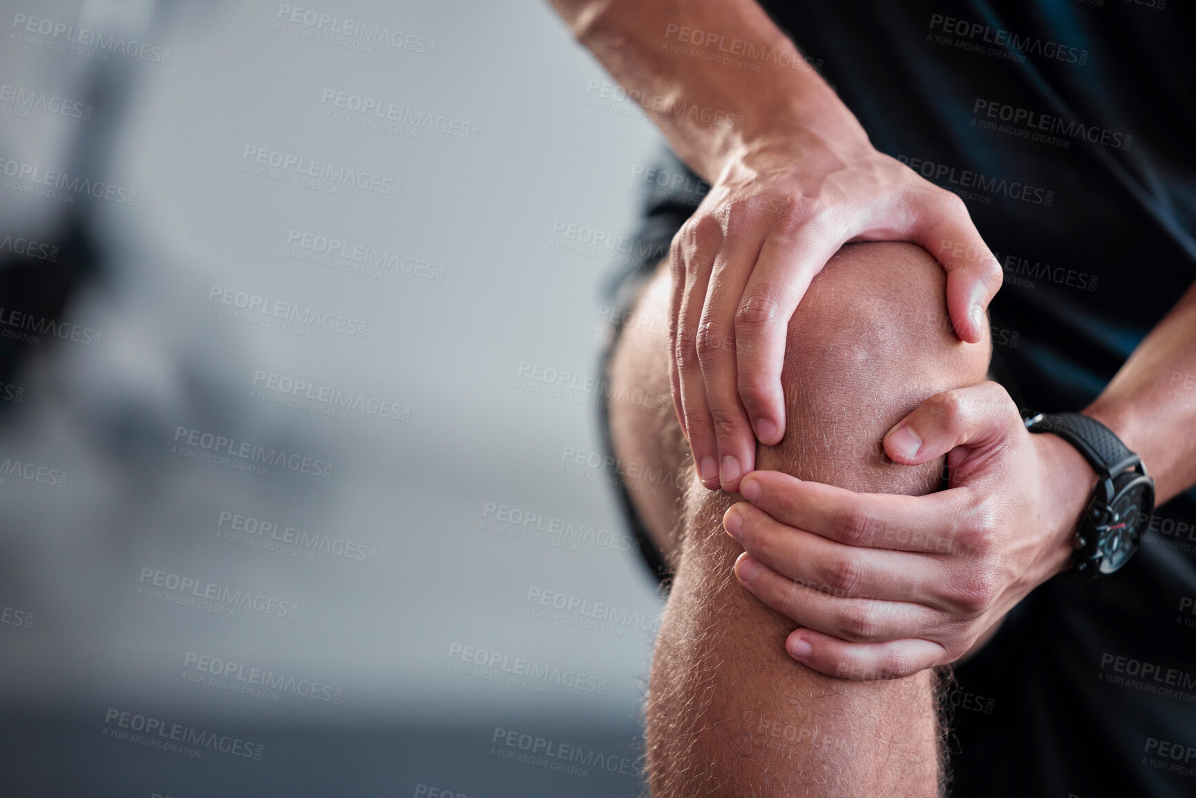 Buy stock photo Hands, knee and pain with a sports man holding a joint injury while training in a gym for health. Fitness, accident and anatomy with a male athlete suffering from an injured body during exercise