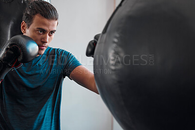 Buy stock photo Sports, boxing and man with punching bag in gym for training, exercise or workout. Boxer, athlete and male fighter punch for fight, competition or practice match, health and wellness for strength.