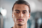 Portrait, sweat and intensity with a sports man closeup in the gym for a cardio or endurance workout. Fitness, exercise and focus with a male athlete taking a break after health training for wellness