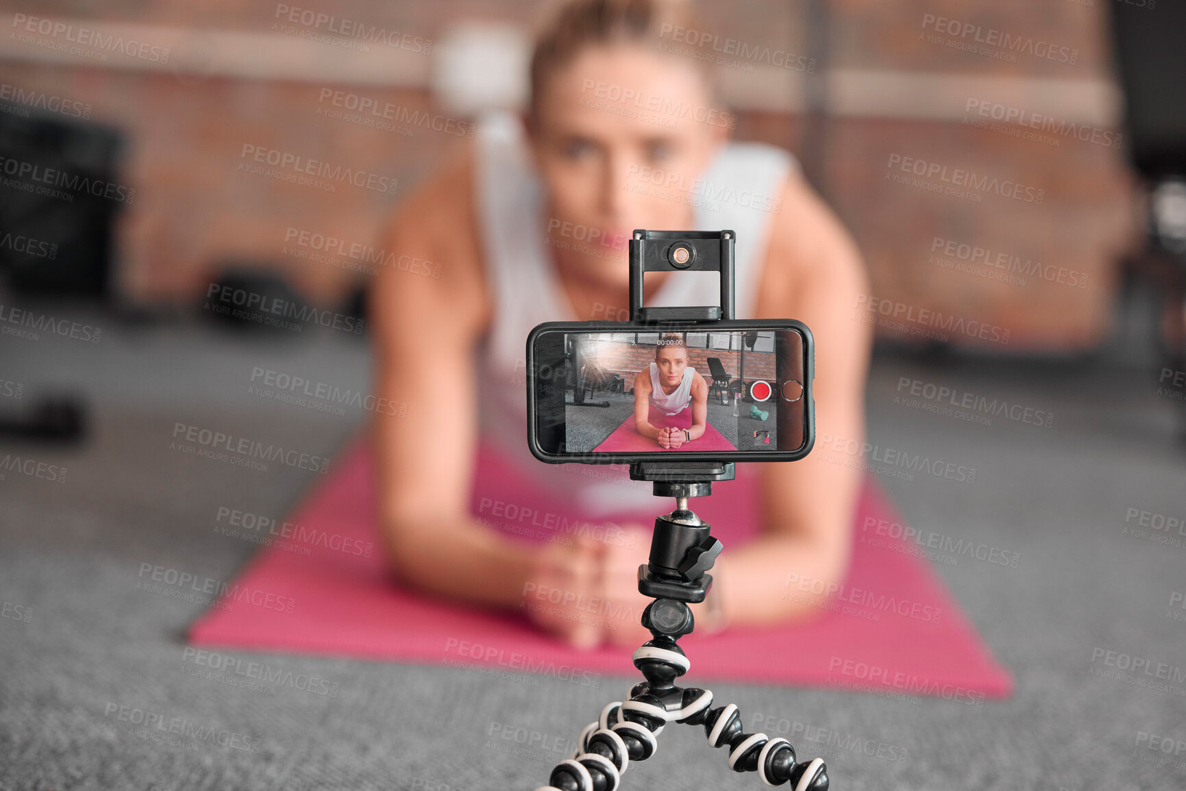 Buy stock photo Live streaming, fitness and phone of woman exercise, pilates or workout on social media or video platform on tripod. Gen z athlete, sports influencer or content creator training on smartphone screen