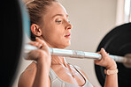 Exercise, weightlifting and a woman bodybuilder in the gym for a workout to build a strong muscular physique. Fitness, bodybuilding and a female weightlifter training her body in a wellness center