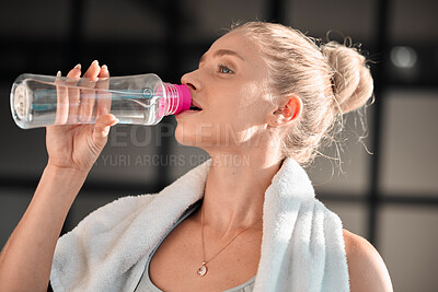 Fitness, athlete and woman drinking water in gym after workout, training or exercise. Sports, nutrition and thirsty athletic female drink liquid aqua from bottle for hydration, health and wellness