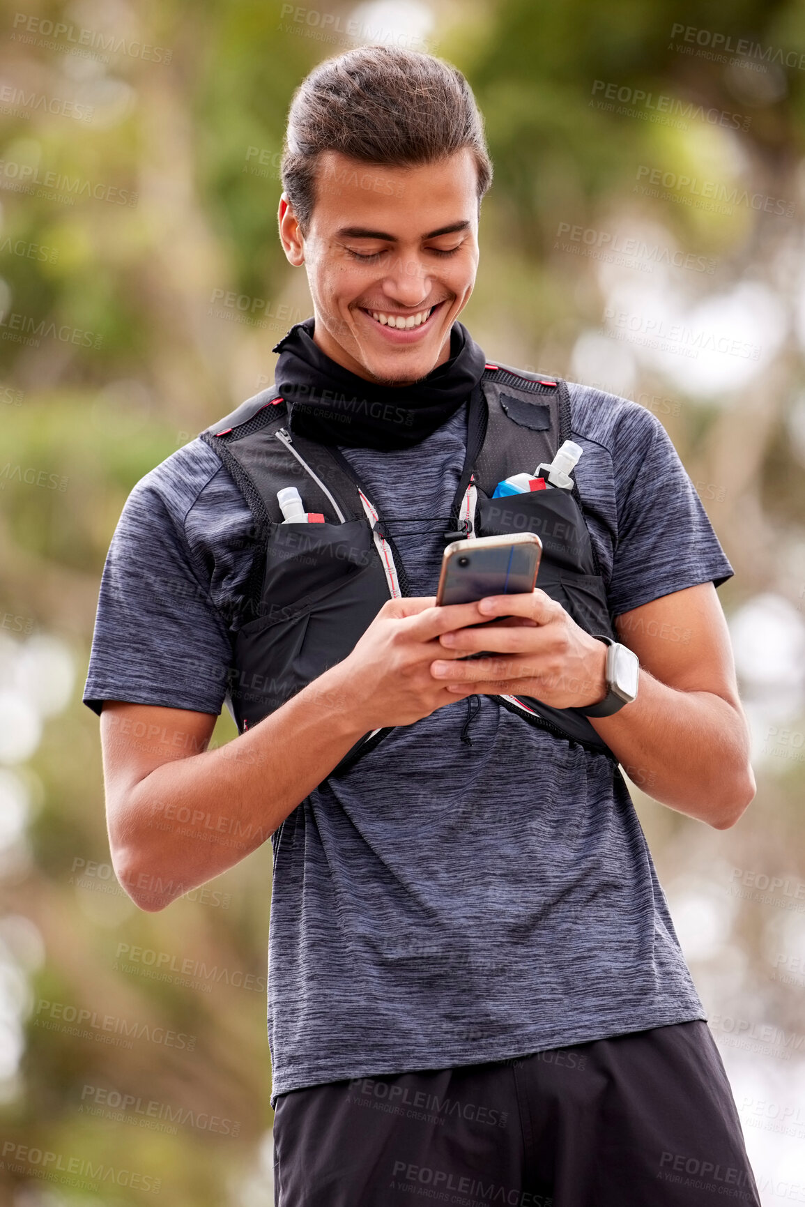 Buy stock photo Fitness, man and phone with smile for social media, communication or chatting in nature. Happy active male smiling on mobile smartphone for chat, texting or networking after outdoor workout exercise