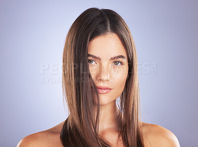 Buy stock photo Beauty, woman and hair care portrait in studio for texture, growth and healthy shine on blue background. Aesthetic female model serious about haircare, and cosmetic for salon or hairdresser results