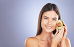 Space, happy and a portrait of a woman with an avocado isolated on a blue background in a studio. Skincare, hair care and a girl with a food for a diet, nutrition and glow of skin with mockup